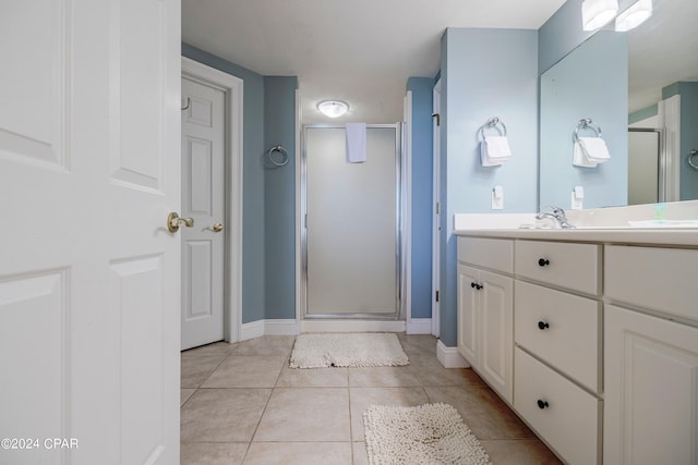 bathroom with a shower with door, tile flooring, and large vanity