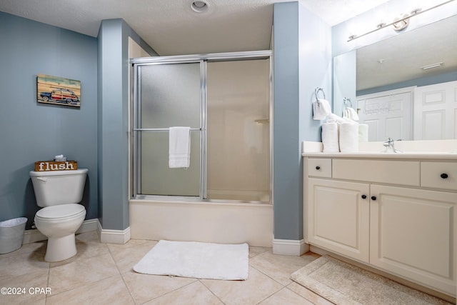 full bathroom featuring tile floors, combined bath / shower with glass door, toilet, and vanity