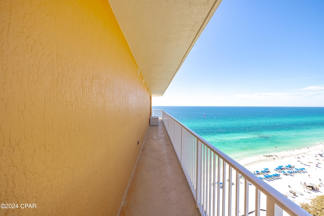 balcony featuring a water view and a view of the beach