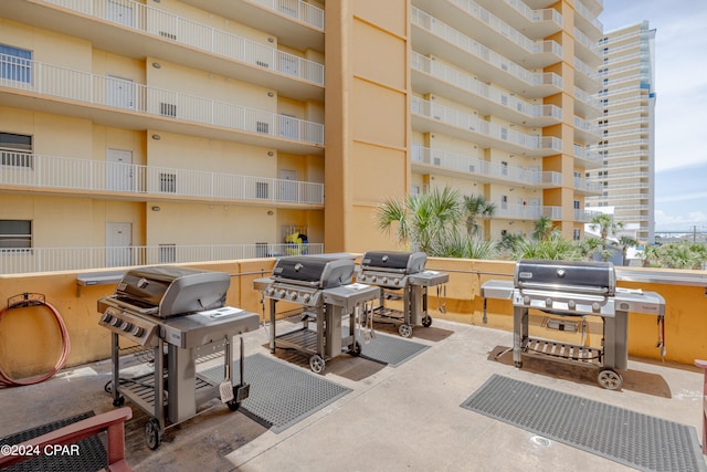 view of terrace with a grill and a balcony