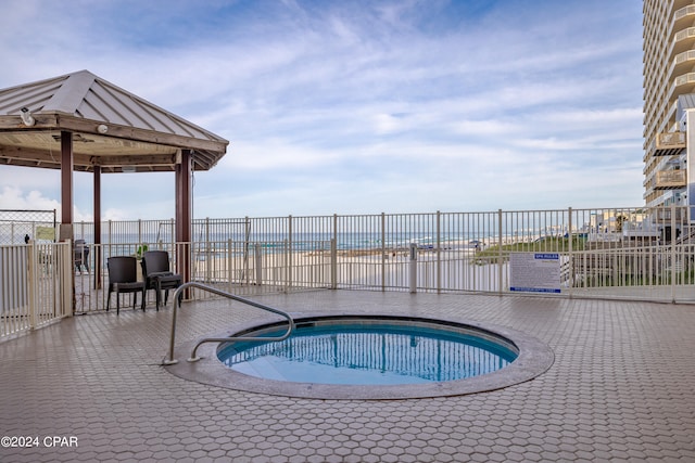 view of swimming pool with a patio area and a hot tub