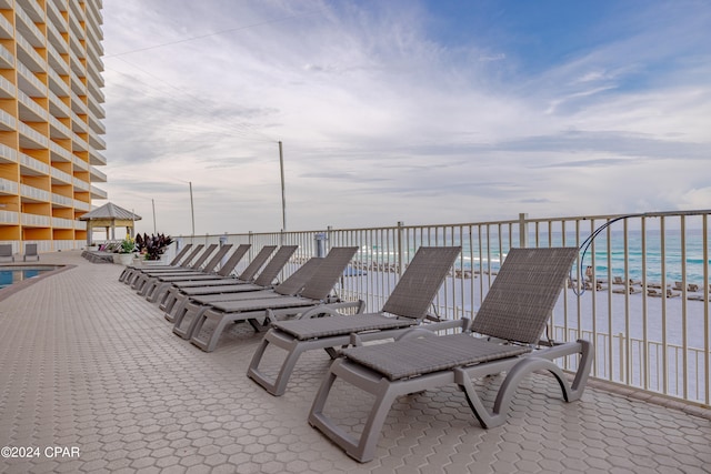 view of patio / terrace featuring a water view and a community pool