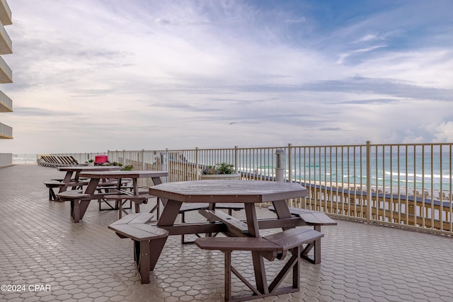 view of terrace featuring a pool and a water view