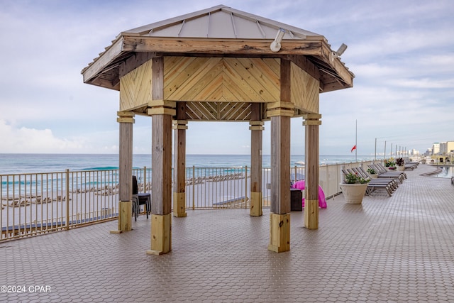 surrounding community featuring a water view and a gazebo