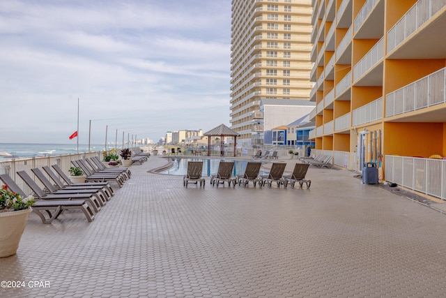 view of terrace with a balcony and a water view