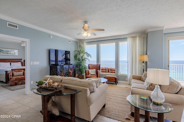 tiled living room featuring a textured ceiling, crown molding, ceiling fan, and a water view