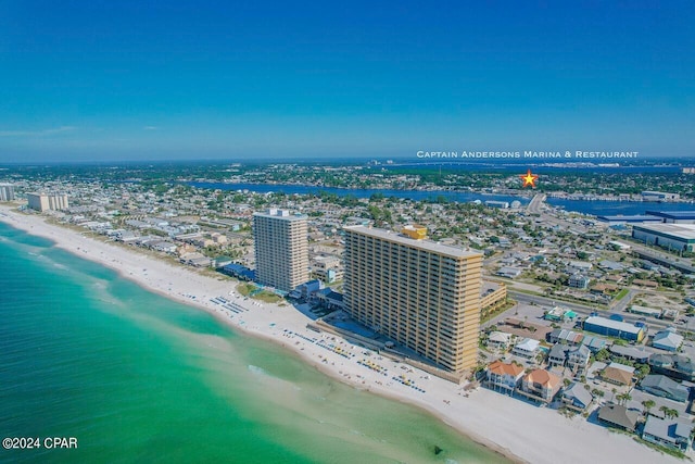 birds eye view of property featuring a beach view and a water view