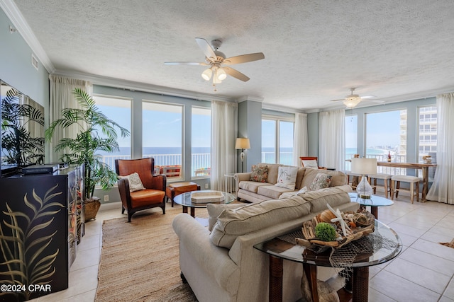 living room with crown molding, a water view, ceiling fan, and light tile floors