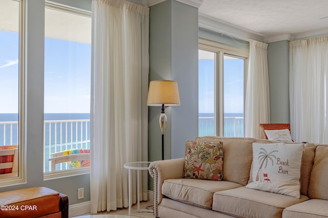 living room with ornamental molding and a water view