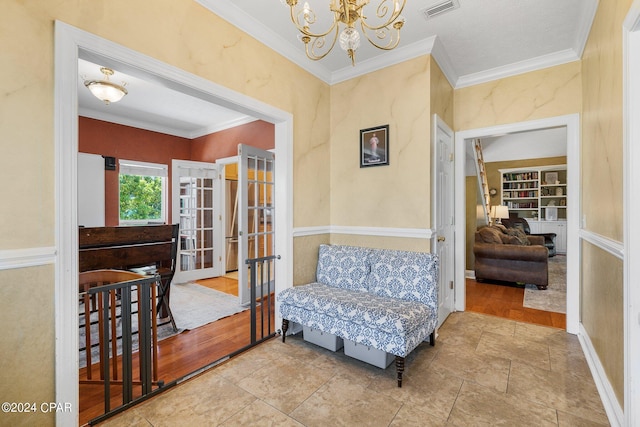 interior space featuring ornamental molding, french doors, visible vents, and an inviting chandelier