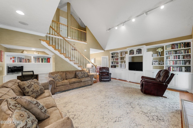 living area with stairs, built in shelves, built in desk, and wood finished floors