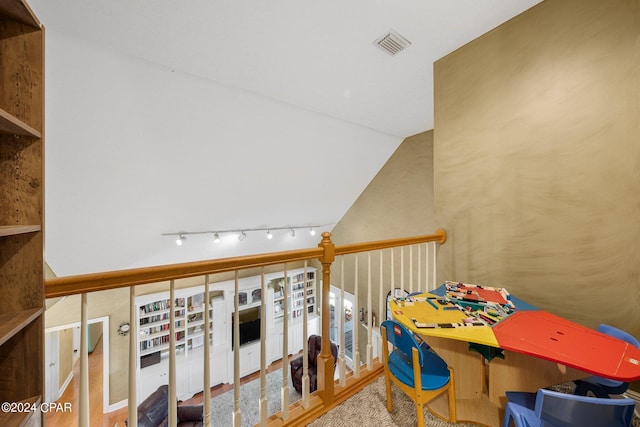 interior space featuring lofted ceiling and visible vents