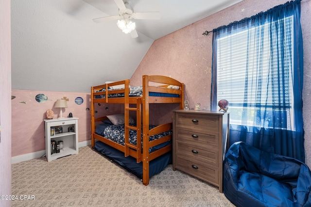 carpeted bedroom with vaulted ceiling, ceiling fan, and baseboards