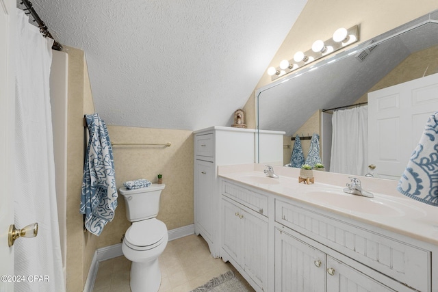 bathroom featuring a textured ceiling, a sink, and lofted ceiling