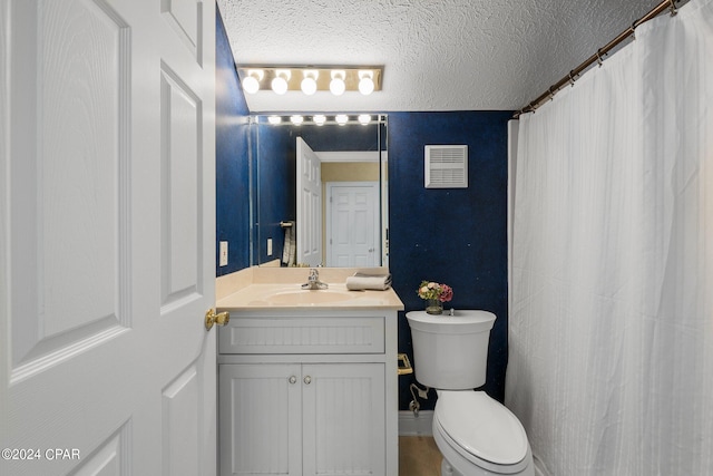 bathroom with toilet, visible vents, a textured ceiling, and vanity