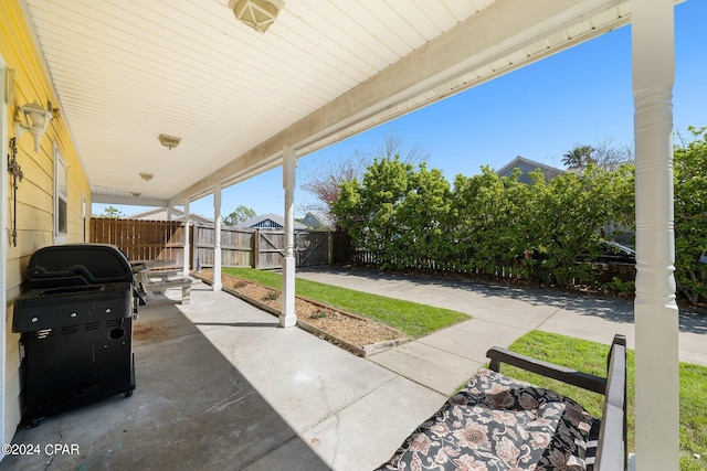 view of patio featuring a fenced backyard and a grill