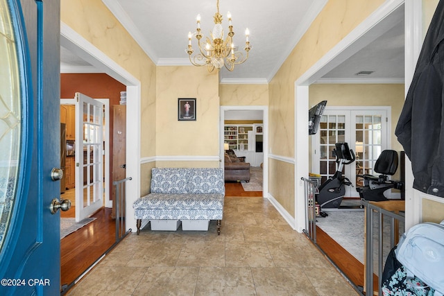 foyer with an inviting chandelier, visible vents, crown molding, and french doors