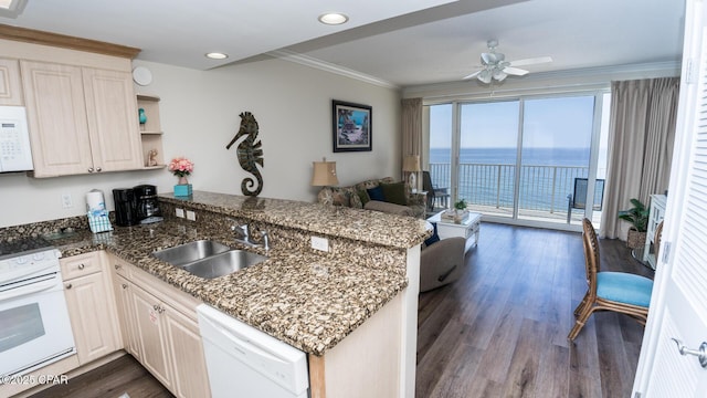 kitchen with white appliances, dark wood-style floors, a peninsula, crown molding, and a sink