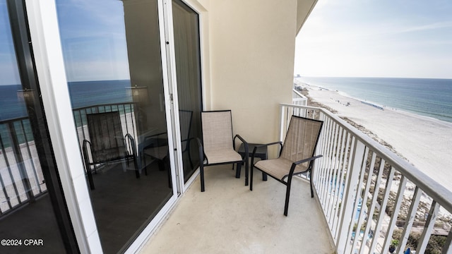 balcony with a water view and a beach view