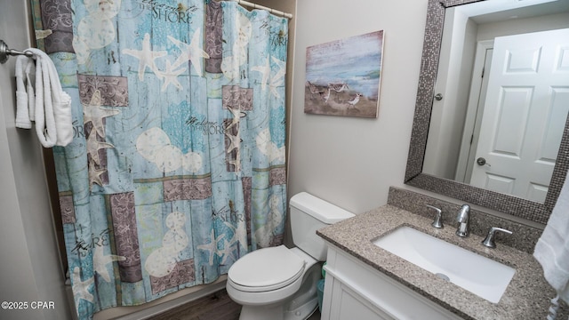 full bathroom featuring toilet, a shower with curtain, wood finished floors, and vanity