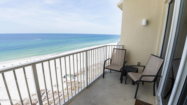 balcony with a beach view and a water view