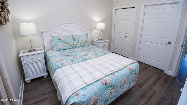 bedroom with baseboards and dark wood finished floors