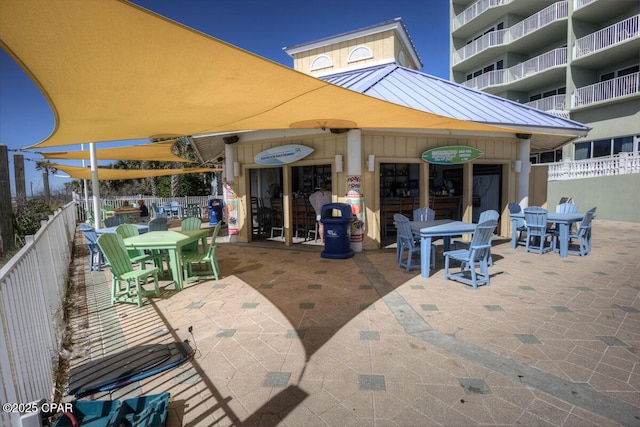 view of patio featuring fence and outdoor dining area