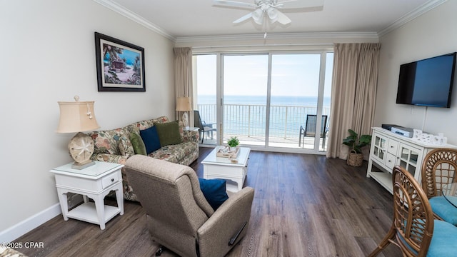 living room featuring ornamental molding, a ceiling fan, baseboards, and wood finished floors