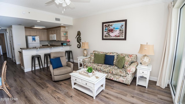 living room featuring ornamental molding, wood finished floors, and baseboards