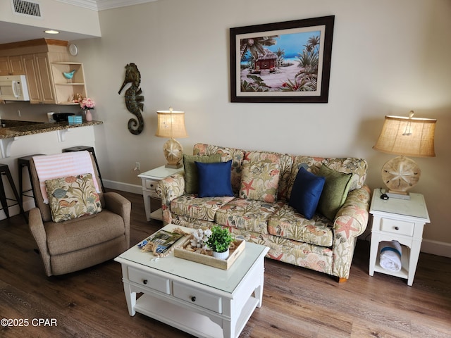 living room with hardwood / wood-style floors and ornamental molding