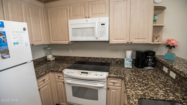 kitchen with dark stone counters, white appliances, light brown cabinetry, and open shelves