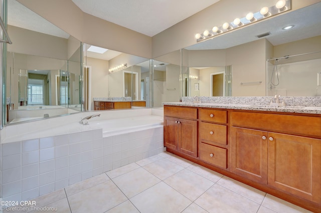 bathroom with a textured ceiling, tile floors, and dual bowl vanity