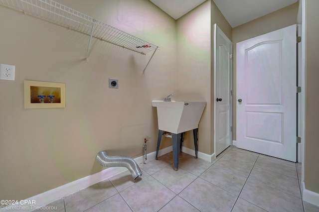 laundry room with hookup for a washing machine, light tile flooring, and electric dryer hookup