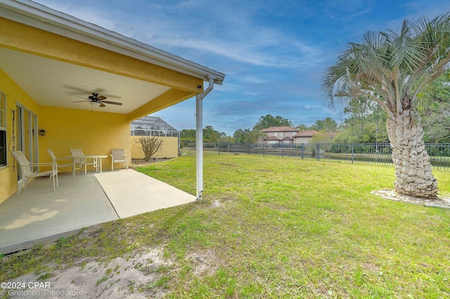 view of yard with a patio area and ceiling fan