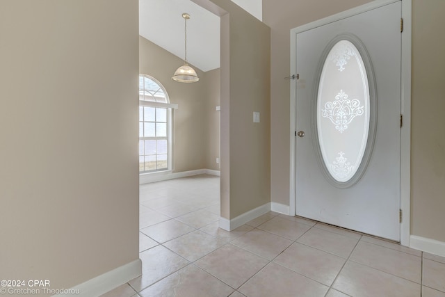 tiled entryway featuring vaulted ceiling