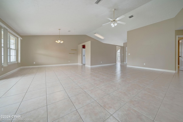 unfurnished room featuring lofted ceiling, light tile flooring, and ceiling fan with notable chandelier