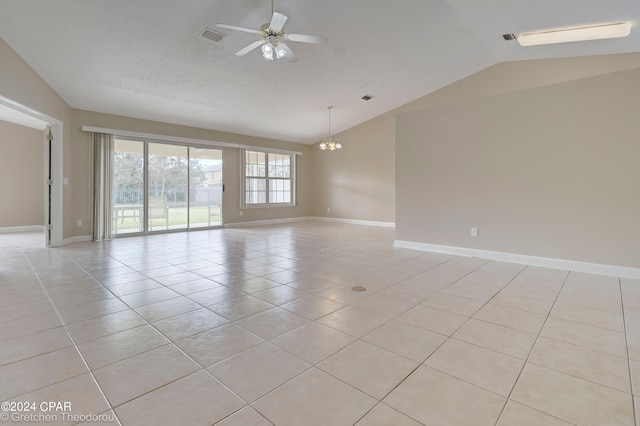 spare room featuring lofted ceiling, ceiling fan with notable chandelier, and light tile flooring