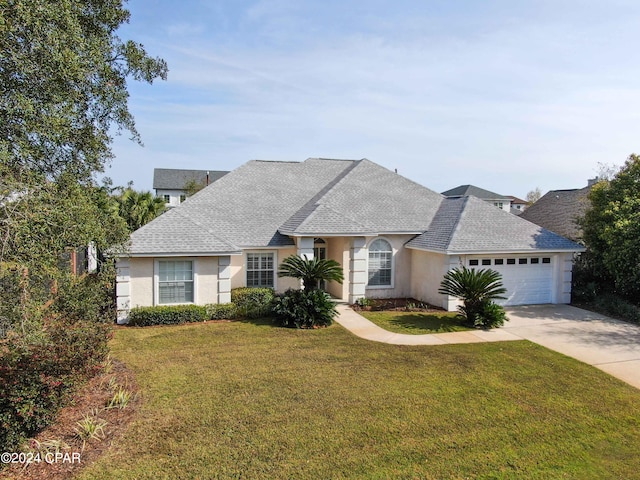 view of front of house featuring a front yard and a garage