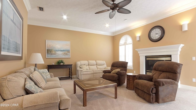 living room featuring a textured ceiling, crown molding, ceiling fan, and light colored carpet