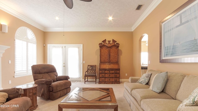 living room with light carpet, a healthy amount of sunlight, french doors, and crown molding