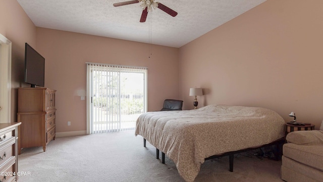 bedroom featuring a textured ceiling, access to exterior, ceiling fan, and light colored carpet