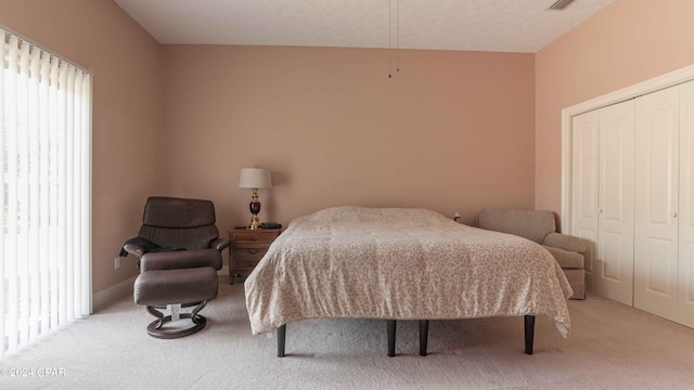 bedroom with a closet and light colored carpet