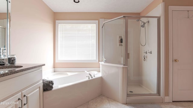 bathroom featuring separate shower and tub, vanity, and a wealth of natural light