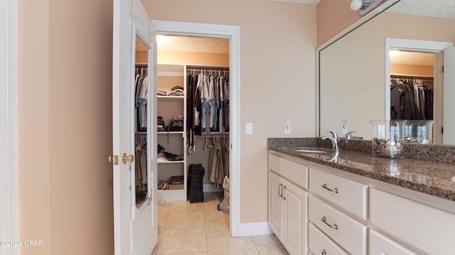 bathroom featuring a textured ceiling, vanity, and tile flooring