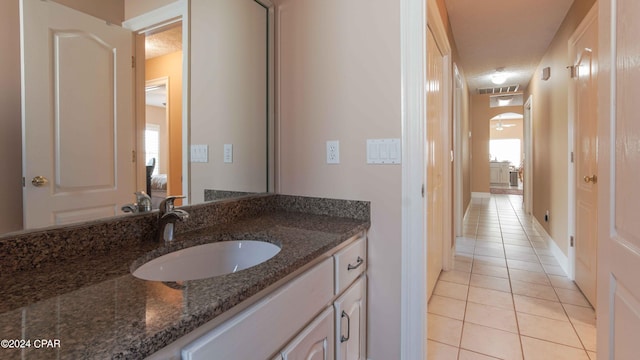 bathroom with tile flooring and vanity