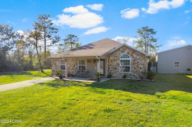 ranch-style house featuring a patio and a front lawn