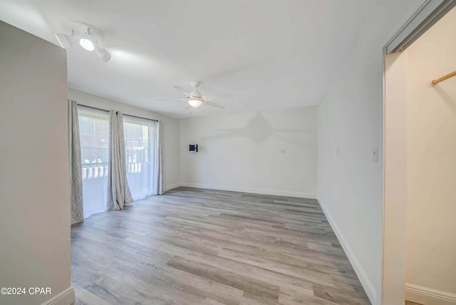 spare room with light wood-type flooring and ceiling fan