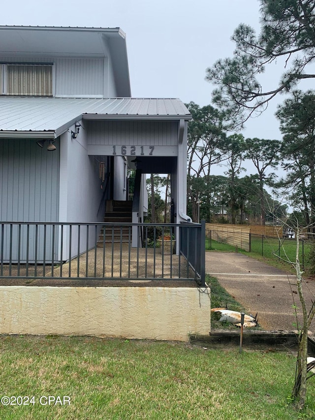 doorway to property featuring a lawn