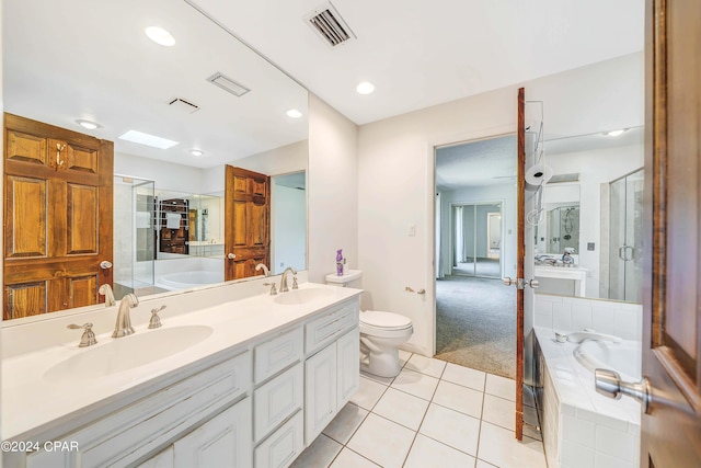 full bathroom with independent shower and bath, vanity, toilet, and tile patterned floors