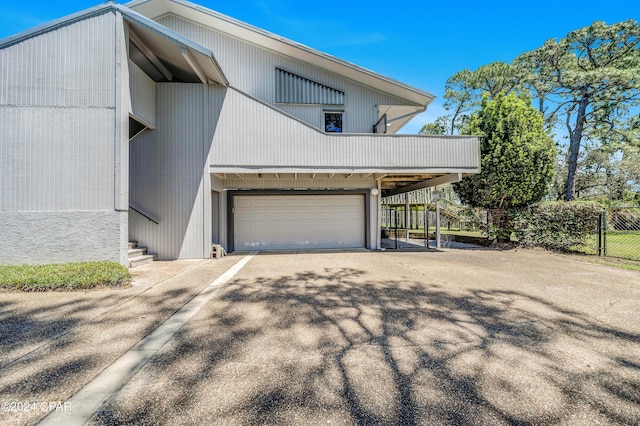 view of home's exterior featuring a garage and a carport